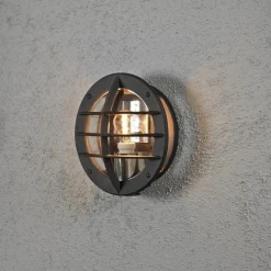 Konstsmide Oden vegglampe utendørs IP23 m/stikkontakt - Svart/klart glass Svart / Klar